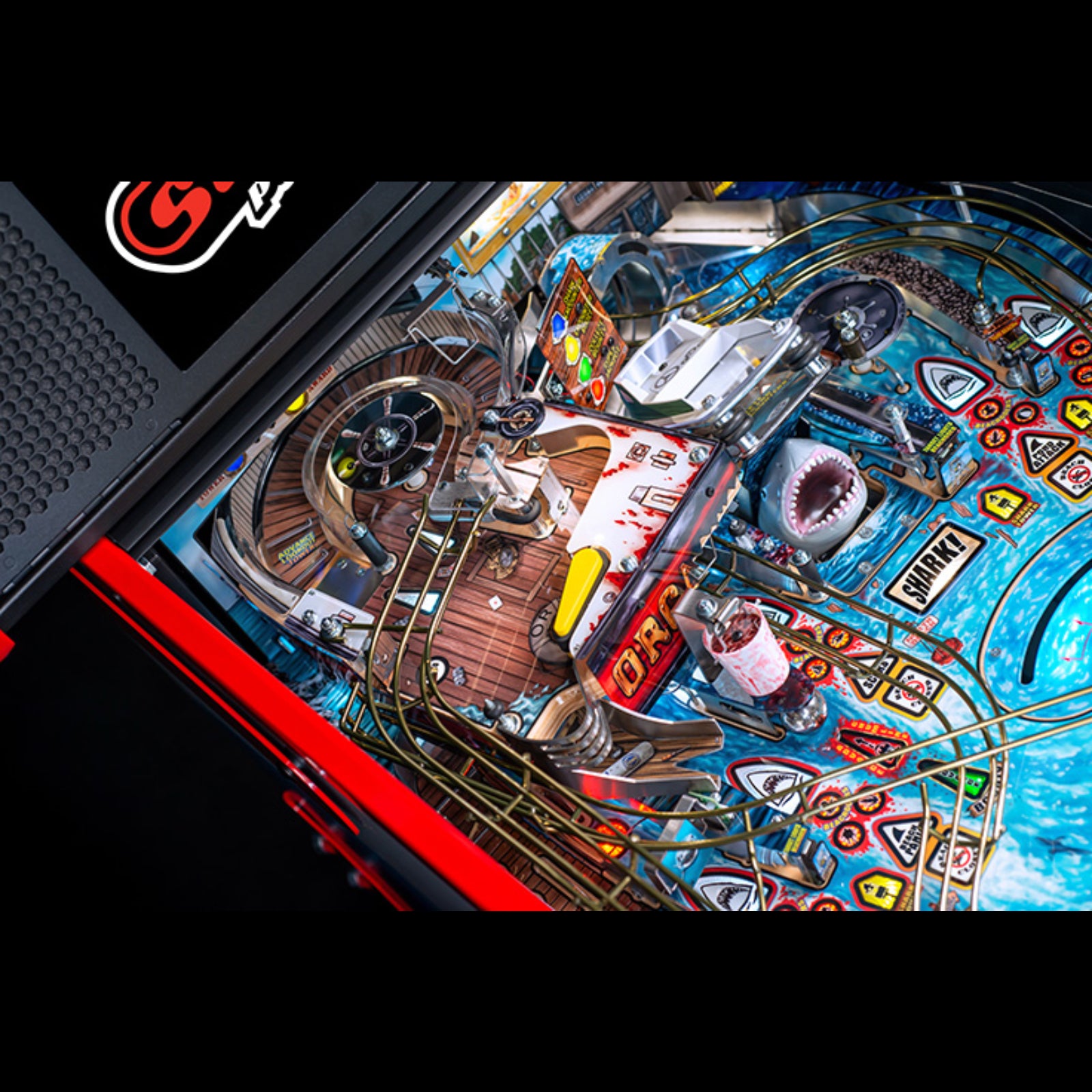 Nitro Pinball Sales Jaws 50th Annyversary Close-up of a colorful pinball machine with various elements and a brand logo.