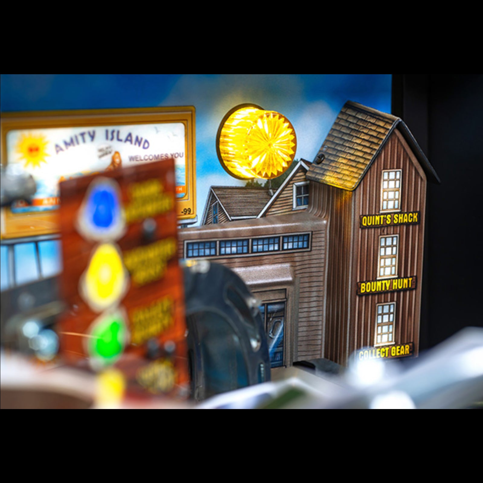 Nitro Pinball Sales Jaws 50th Annyversary Toy model of a building with 'Quint's Shack' and 'Amity Island' signs, featuring glowing elements.