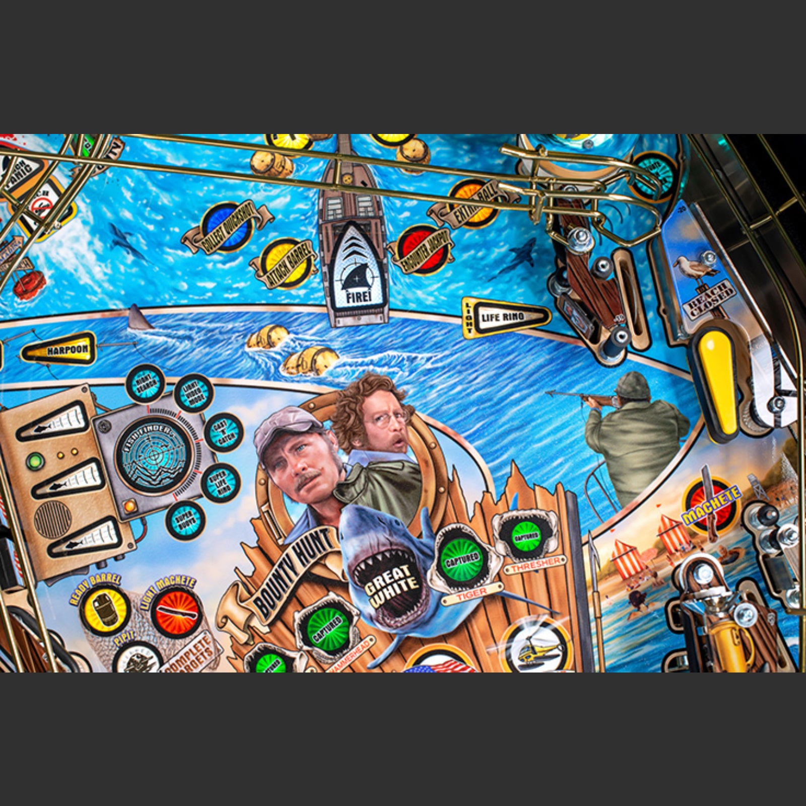 Nitro Pinball Sales Jaws 50th Annyversary Close-up of a pinball machine with various symbols and graphics on a blue background
