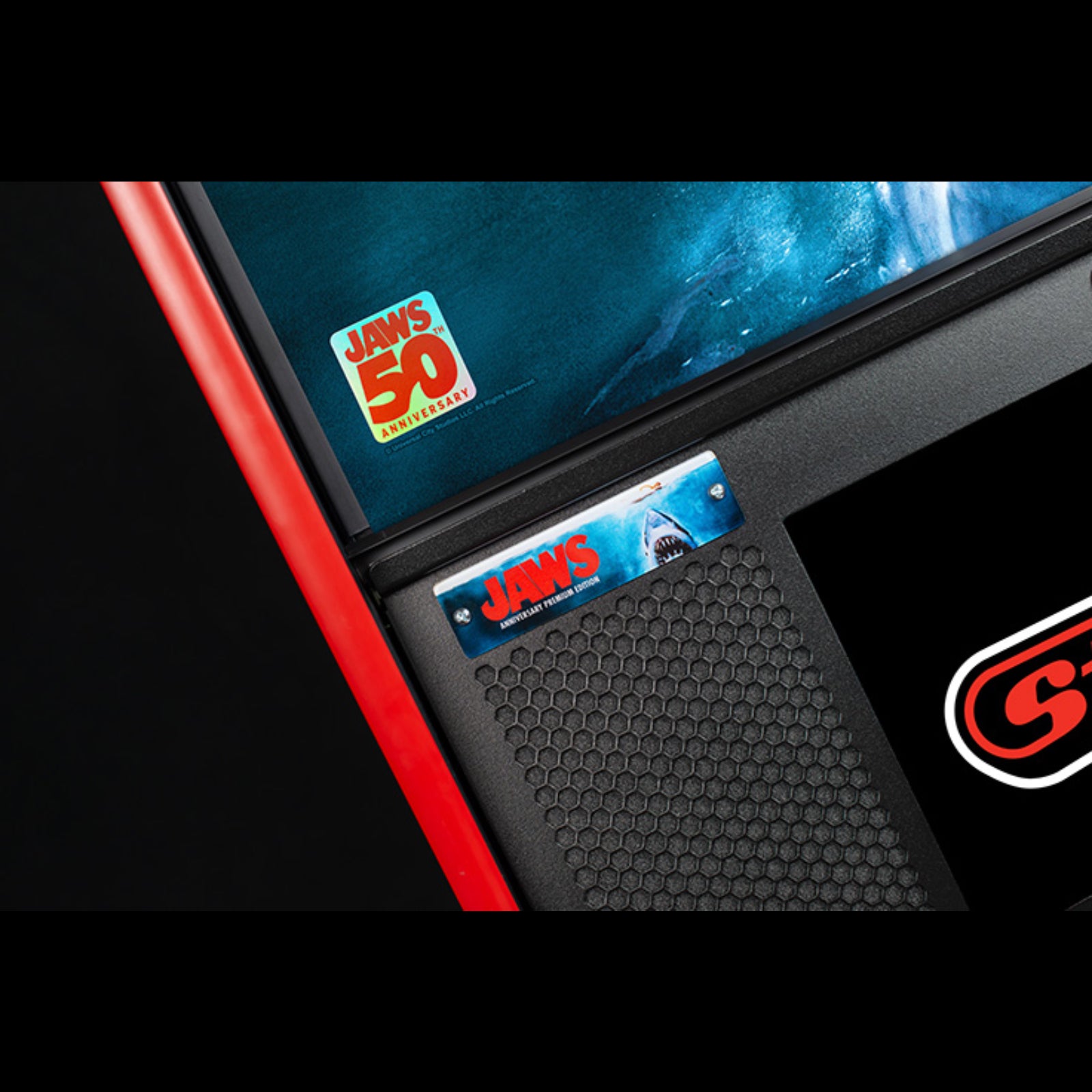 Nitro Pinball Sales Jaws 50th Annyversary Close-up of a product with 'Jaws' branding and a red border.
