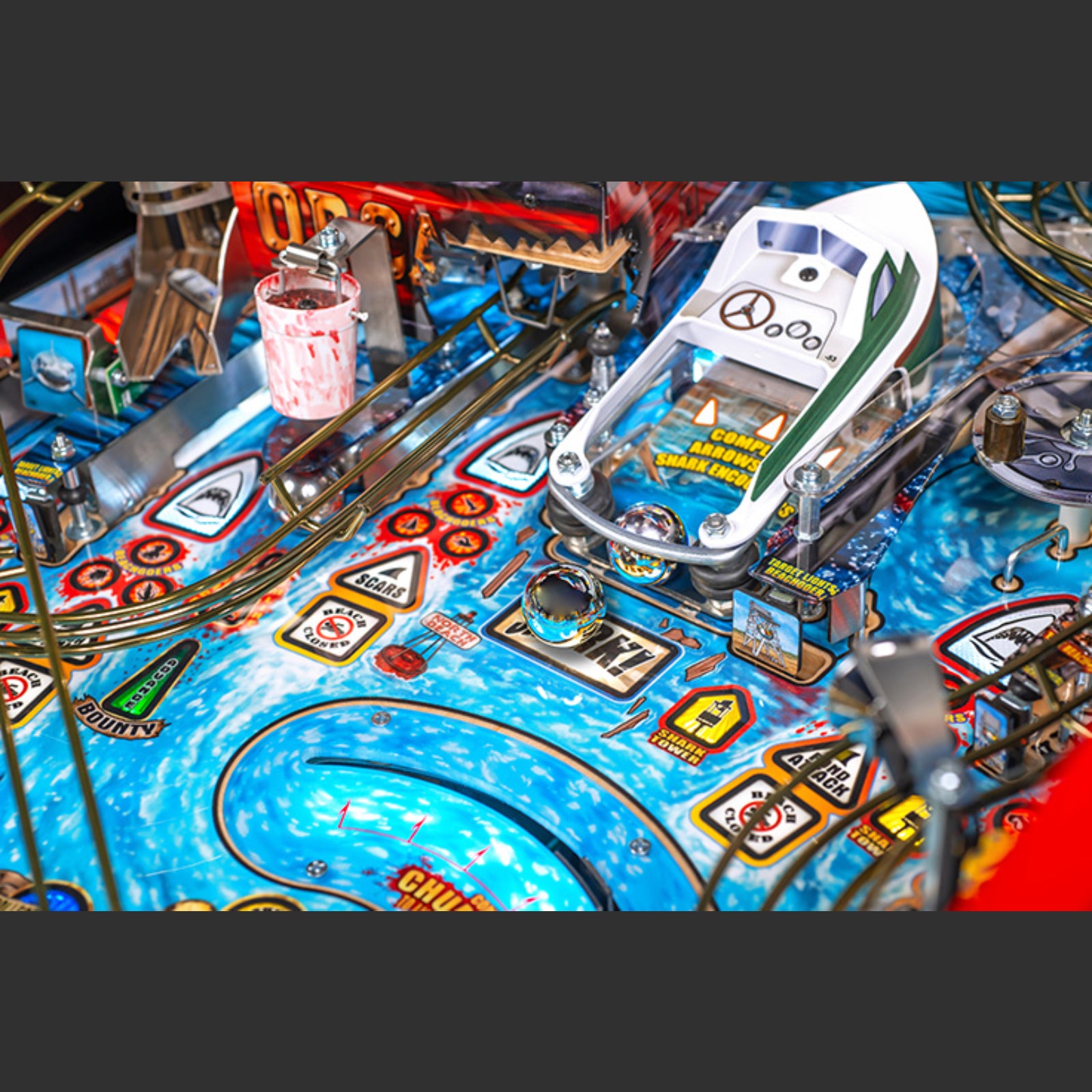 Nitro Pinball Sales Jaws 50th Annyversary Close-up of a pinball machine with colorful design and various elements.