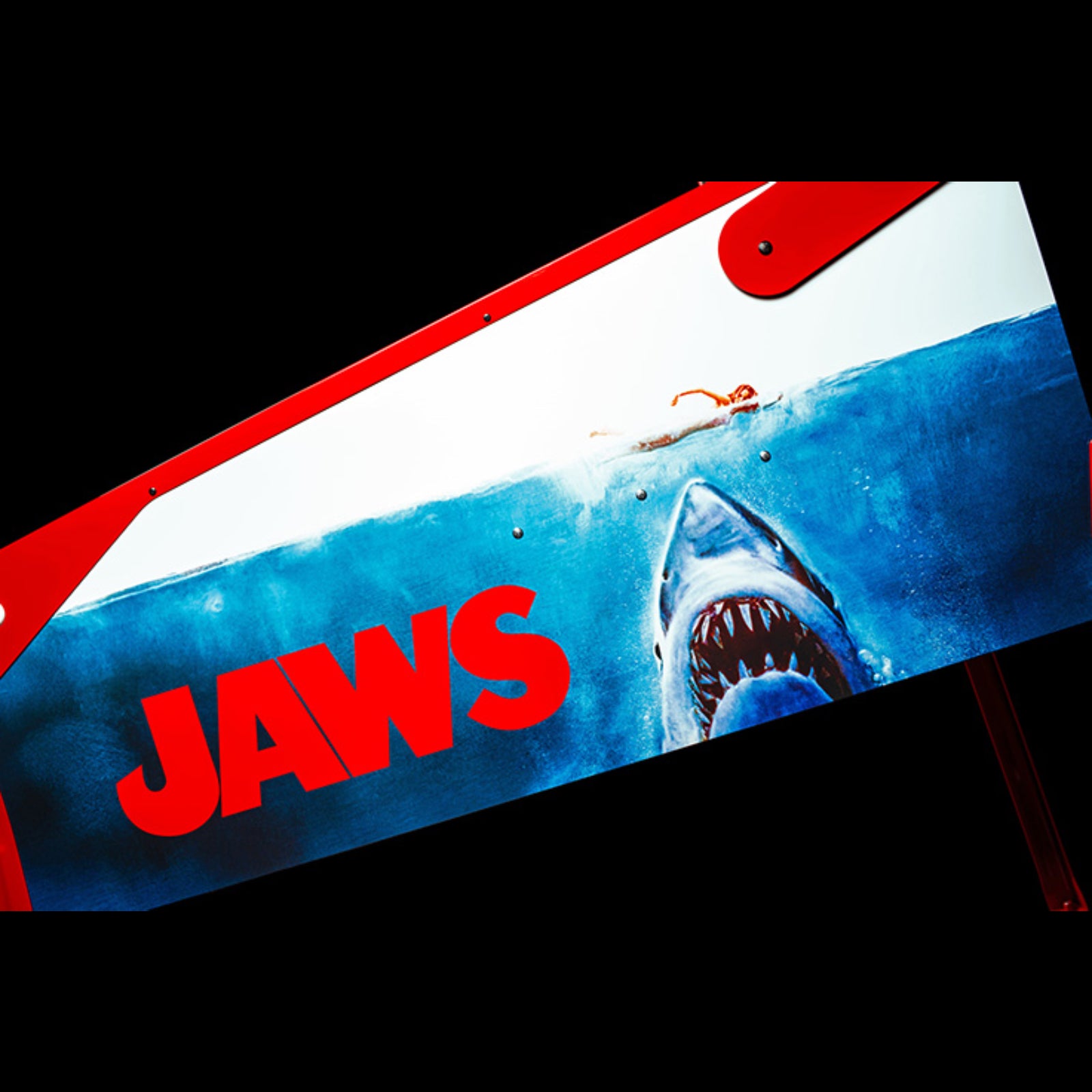 Nitro Pinball Sales Jaws 50th Annyversary Surfboard with 'JAWS' logo and shark graphic on a black background