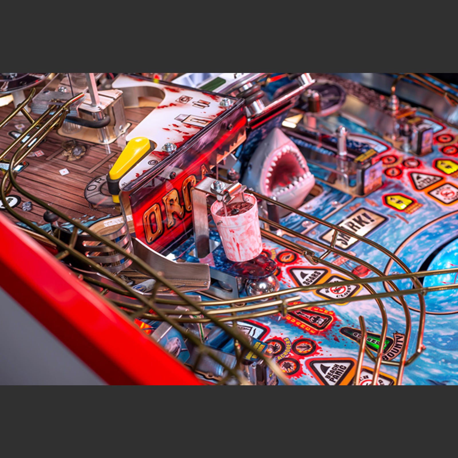 Nitro Pinball Sales Jaws 50th Annyversary Close-up of a pinball machine with a shark-themed design